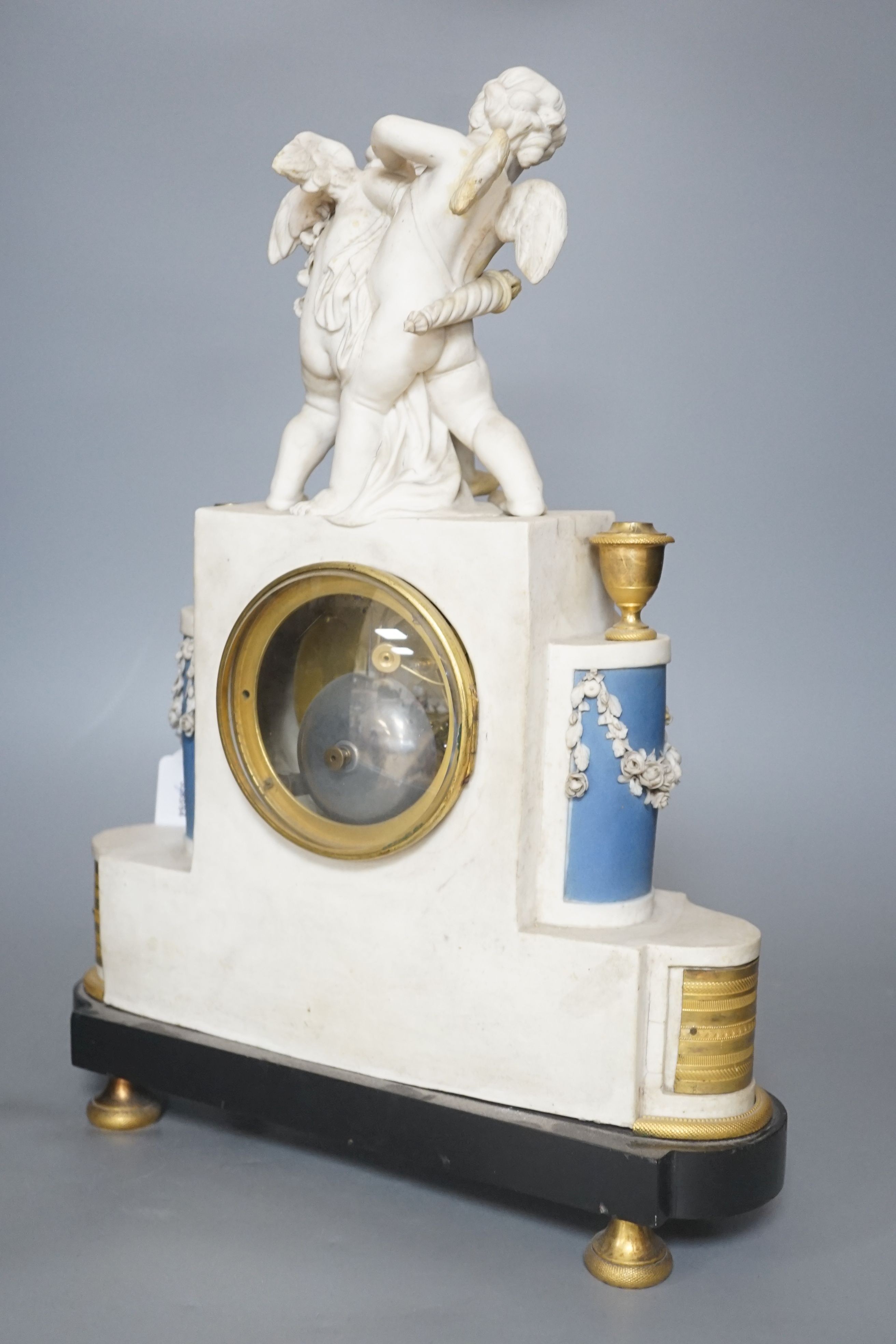 A 19th century French biscuit porcelain and ormolu mounted mantel clock, 43 cm high